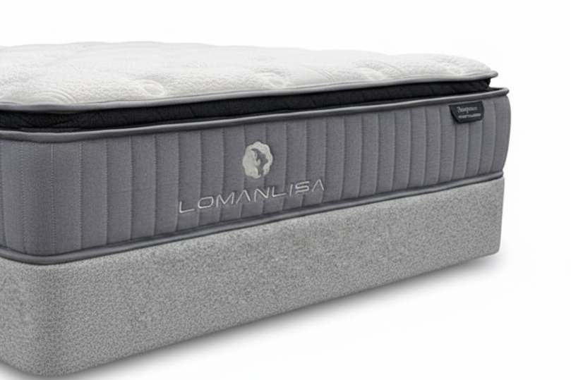 Gray mattress with LomanLisa branding on a plain background